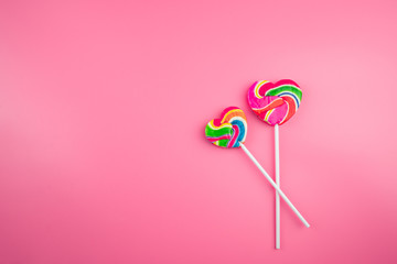 Multicolored lollipops on a pink background