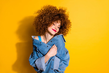 Close-up portrait of her she nice cute lovely charming attractive winsome sweet cheerful wavy-haired girl covering cosy jacket isolated over bright vivid shine yellow background