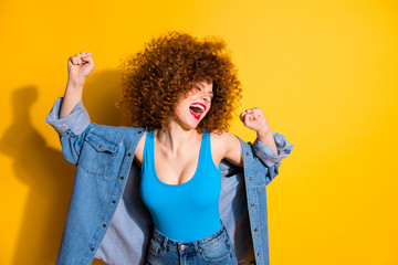 Close up photo beautiful amazing yell she her lady wavy fluffy curls excited hands arms raised I am best wear casual jeans denim shirt blue tank top outfit clothes isolated yellow bright background