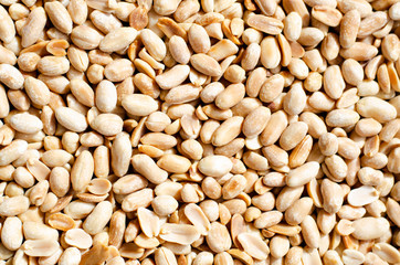 Background with lots of peeled peanuts.