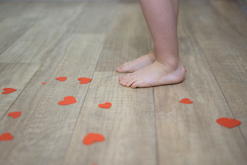 Children's feet on floor.