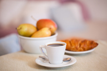 Coffee at home. Breakfast with croissants, coffee and fruits on the table
