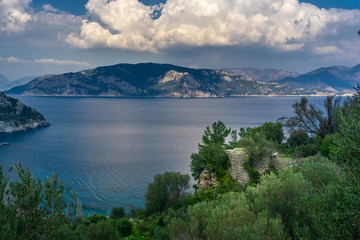 Marmaris, Turkey. Island, sea and cloudy sky landscape. Amos Ancient City, City Walls from Kumlubuk. Lycian way.