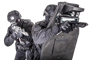 SWAT team behind ballistic shield studio shoot - obrazy, fototapety, plakaty