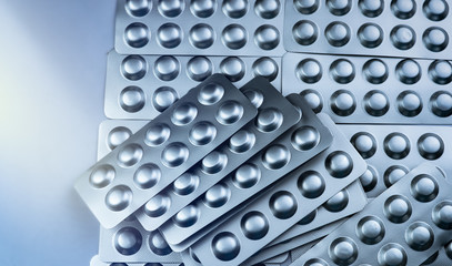 Painkiller and muscle relaxant medicine. Pile of silver aluminium foil blister pack. Pharmaceutics and pharmaceutical industry concept. Drug use in hospital. Global healthcare. Pharmacy background.