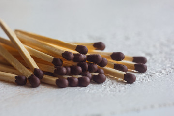 a pile of matches close up on a white table. Macro fire igniter on blurred background