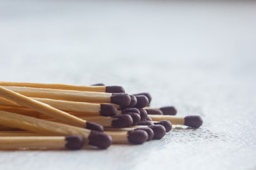 a pile of matches close up on a white table. Macro fire igniter on blurred background