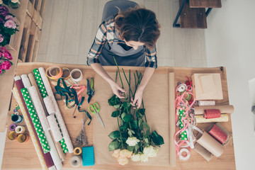 Top above high angle view photo skilled busy focused lady vendor orangery surprise 8-march 14-february botanical curly haircut nature floral craft art trendy stylish plaid outfit indoors workplace