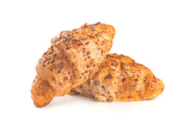 Photo of fresh golden croissants covered sunflower seeds and sesame isolated on white background.
