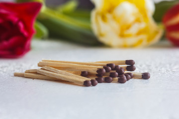 a pile of matches close up on a white table. Macro fire igniter on blurred background
