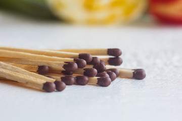 a pile of matches close up on a white table. Macro fire igniter on blurred background