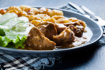 Italian potato dumplings with stew and cucumber salad
