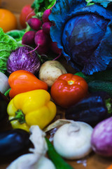 Top view fresh vegetables on the wooden counter of a small vegetable market.