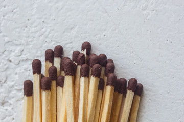 a pile of matches close up on a white table. Macro fire igniter on blurred background. top view