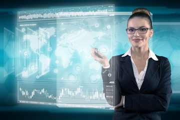 Young business lady works with virtual graphic interface in futuristic office
