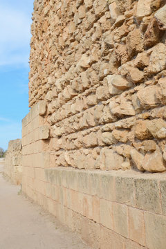 Ruin of the outside wall of the Salamis Theatre tribune captured on vertical picture with blue sky. Salamis was an ancient Greek city-state located in todays Turkish Northern Cyprus