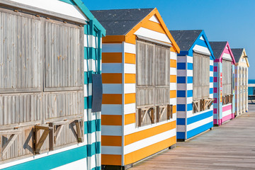 Colorful beach cabanas taken at the beach in Hastings, UK. 