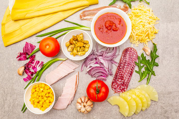 Raw ingredients for pizza, quiche, savory pie. Cooking stone background, top view
