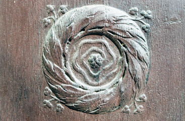 Old Ornate Element on Wooden Material