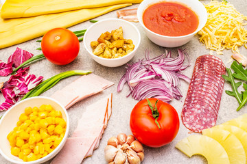 Raw ingredients for pizza, quiche, savory pie. Cooking stone background