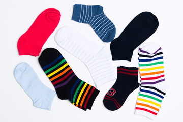 Many various colorful textile socks for warm weather. Legs clothes on white background