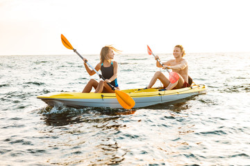 Sporty attractive couple kayaking