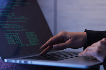 Naklejka na ściany i meble Close up of computer hacker stealing data from laptop.