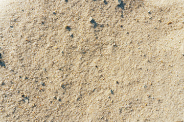 Abstract background of a sandy beach close-up in defocus