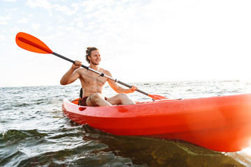 Healthy strong man kayaking