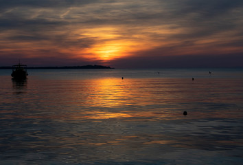 Sunset on the sea in Fazana,Croatia with ship silhouette