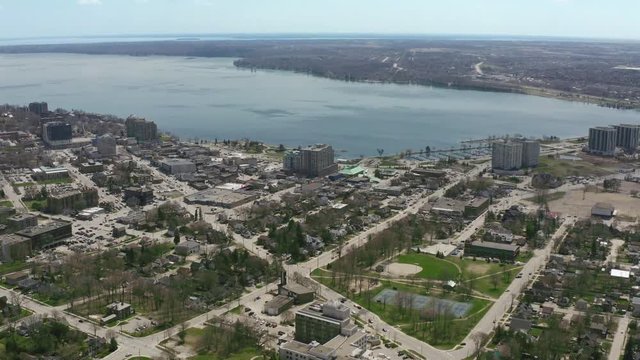 Barrie Ontario Canada 4k Aerial Drone of Downtown Waterfront and Bay in Lake Simcoe. Businesses, Trees, Roads and Water Can Be Seen As Camera Moves Backwards Revealing More