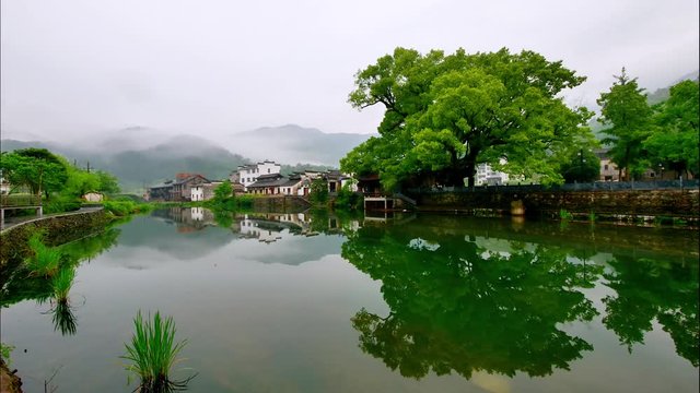 Time lapse of Wuyuan village in morning, beautiful clouds moving up and down in mountains, peaceful river and beautiful hui style buildings, amazing rural landscape, 4k movie, time lapse video.