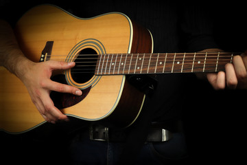 Obraz na płótnie Canvas Acoustic guitar in musician hand