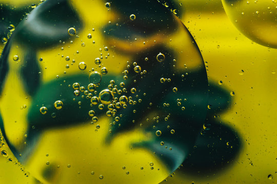 Beautiful Mixing Water And Oil On A Yellow Background.