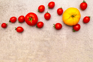 Fresh organic tomatoes. Food cooking stone background. Healthy vegetarian (vegan) eating concept, close up, top view, flat lay, copy space.