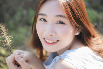 Fototapeta premium Portrait of Young Asian woman girl smile in flower garden