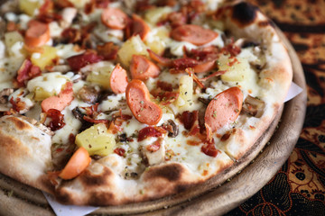 Pizza sausage bacon and pineapple on wooden , pizza hawaiian