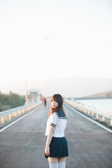 Portrait of Japanese school girl uniform smile with walkway and river