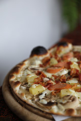 Pizza sausage bacon and pineapple on wooden , pizza hawaiian