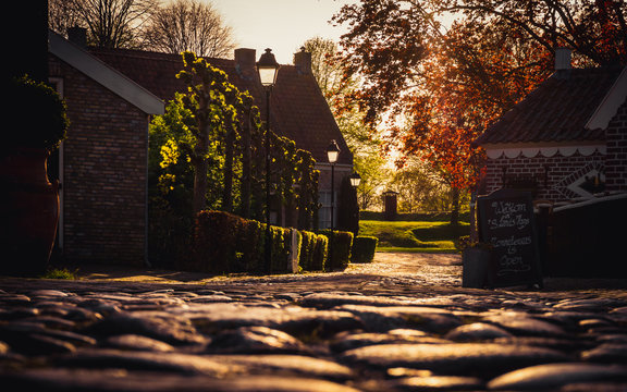 Warm bright sunset light over village houses and pavement- Bourtange, The Netherlands