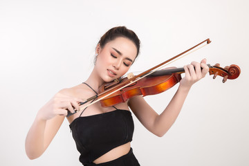 Beautiful young woman playing violin over white background