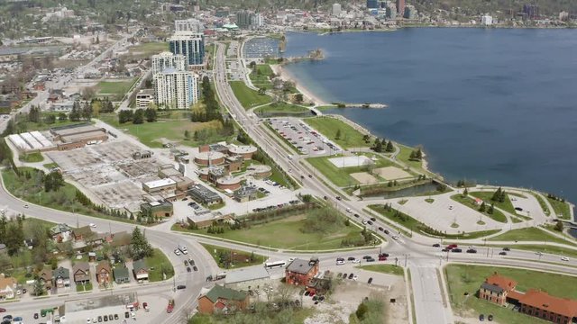 Barrie Ontario Canada 4k Aerial Drone of Downtown, Bay in Lake Simcoe and Centennial Park. Camera Tilts Up and Reveals City and Waterfront