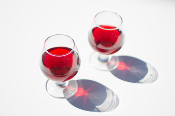 Glasses with red wine on a white background