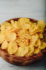 Breakfast cornflakes in a wooden bowl