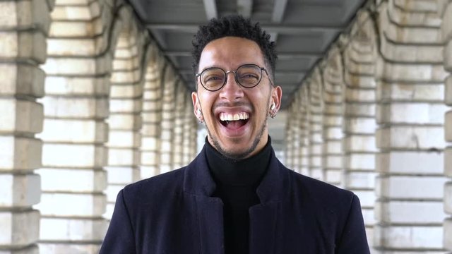 Slow motion of businessman laughing while standing under Pont de Bercy bridge