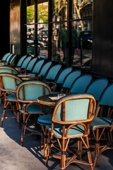 Street view of a coffee terrace with tables and chairs,paris France.Empty coffee terrace in paris,France