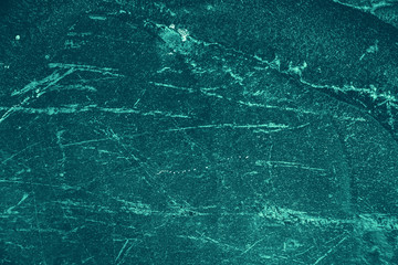 Vintage azure background. Rough painted wall of turquoise color. Imperfect plane of cyan colored. Uneven old decorative toned backdrop of aqzure tint. Texture of teal hue. Ornamental stony surface.