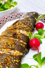 Roasted trout with vegetables walnuts and blue cheese