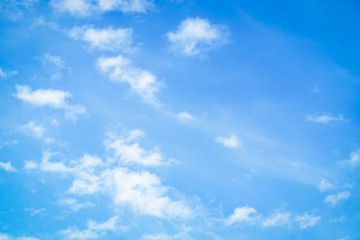 Naklejka na ściany i meble Blue sky with delicate white clouds. Sky background
