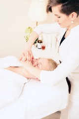 Beautician makes facial massage. cosmetology cabinet. skin care. healthy lifestyle concept.